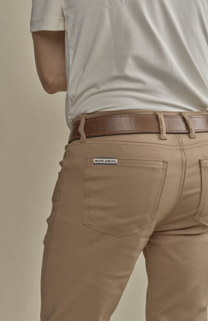 The back pocket and label on tan cotton chinos