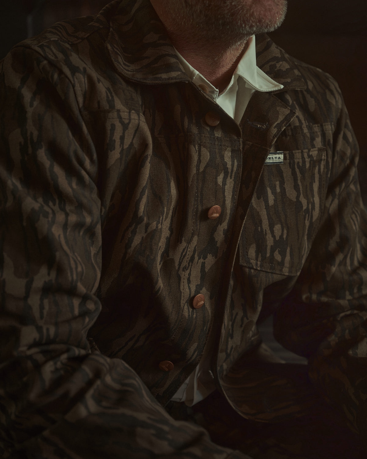 Men's Bottomland canvas jacket by the fireplace