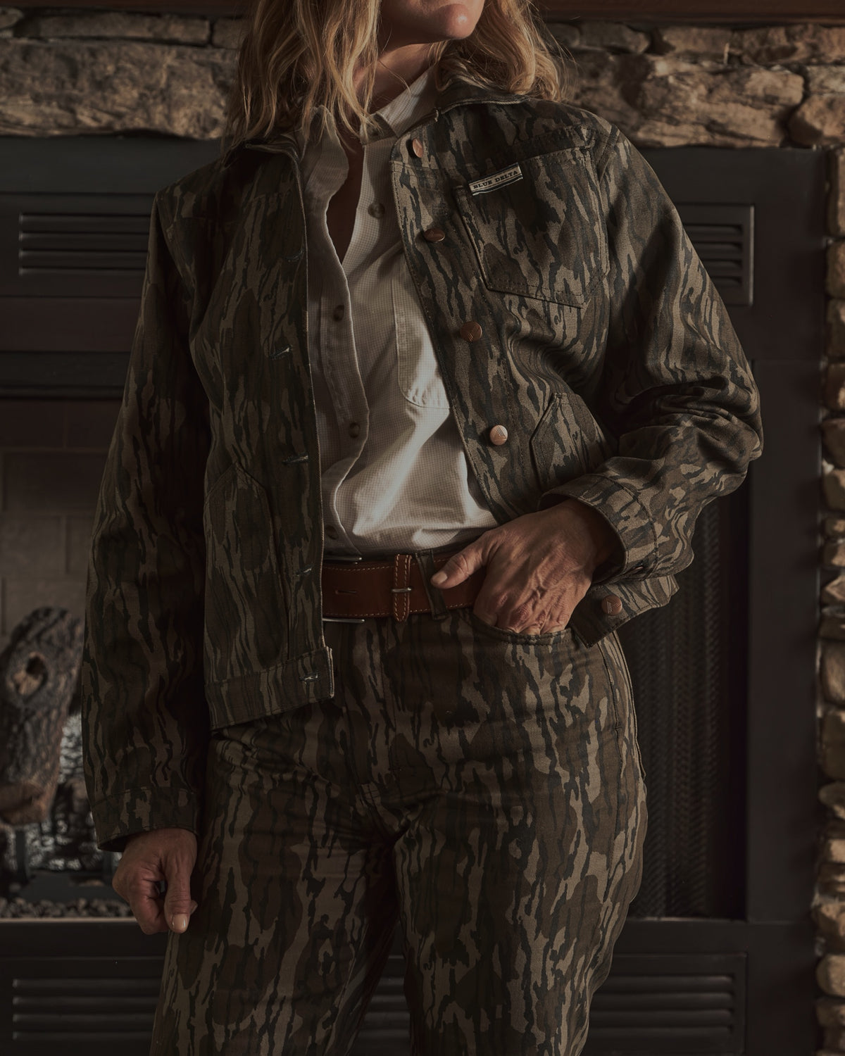 Women's Bottomland canvas jacket and chino by the fireplace