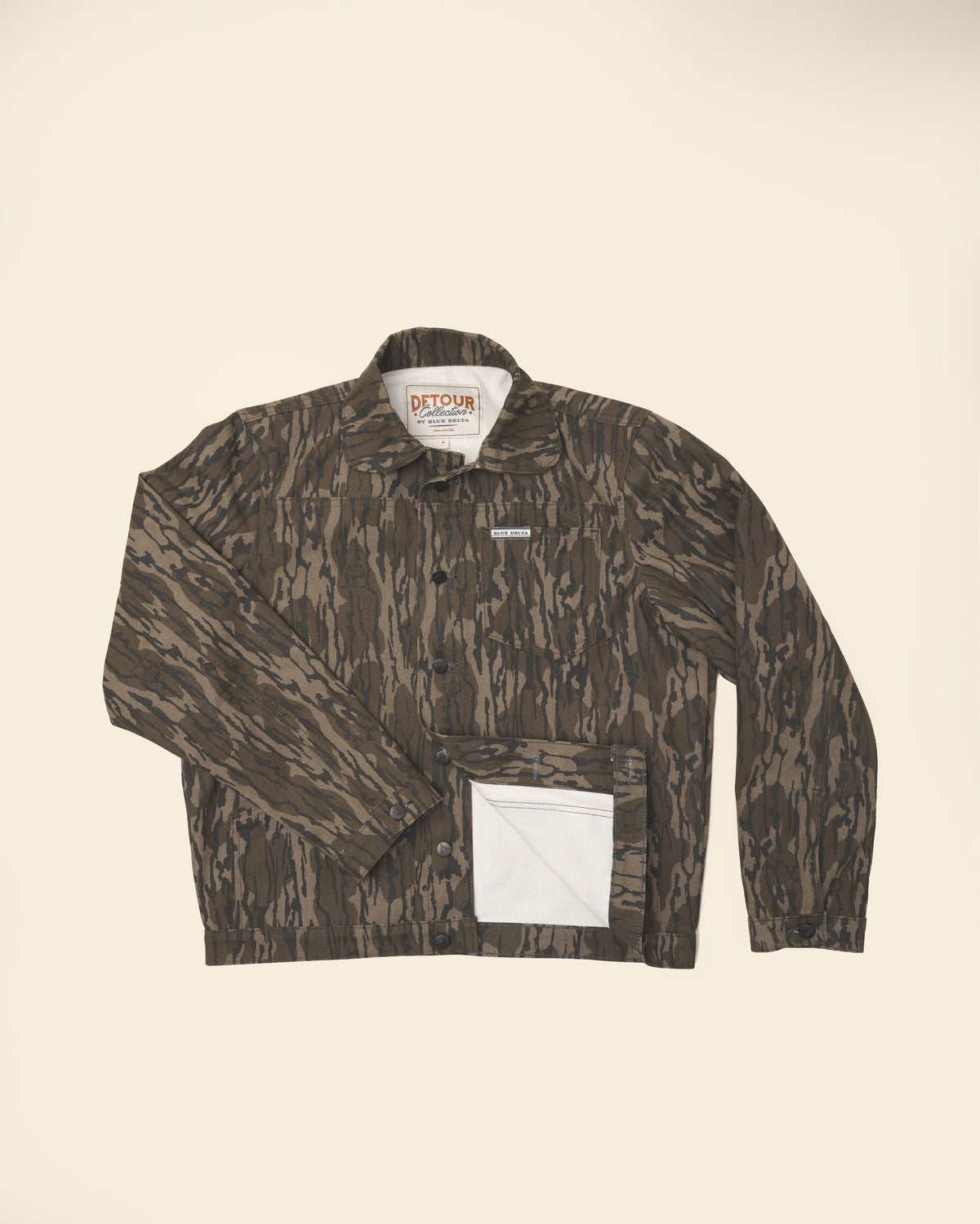 Men's Bottomland canvas jacket laid flat, lower front folded back to show the lining.