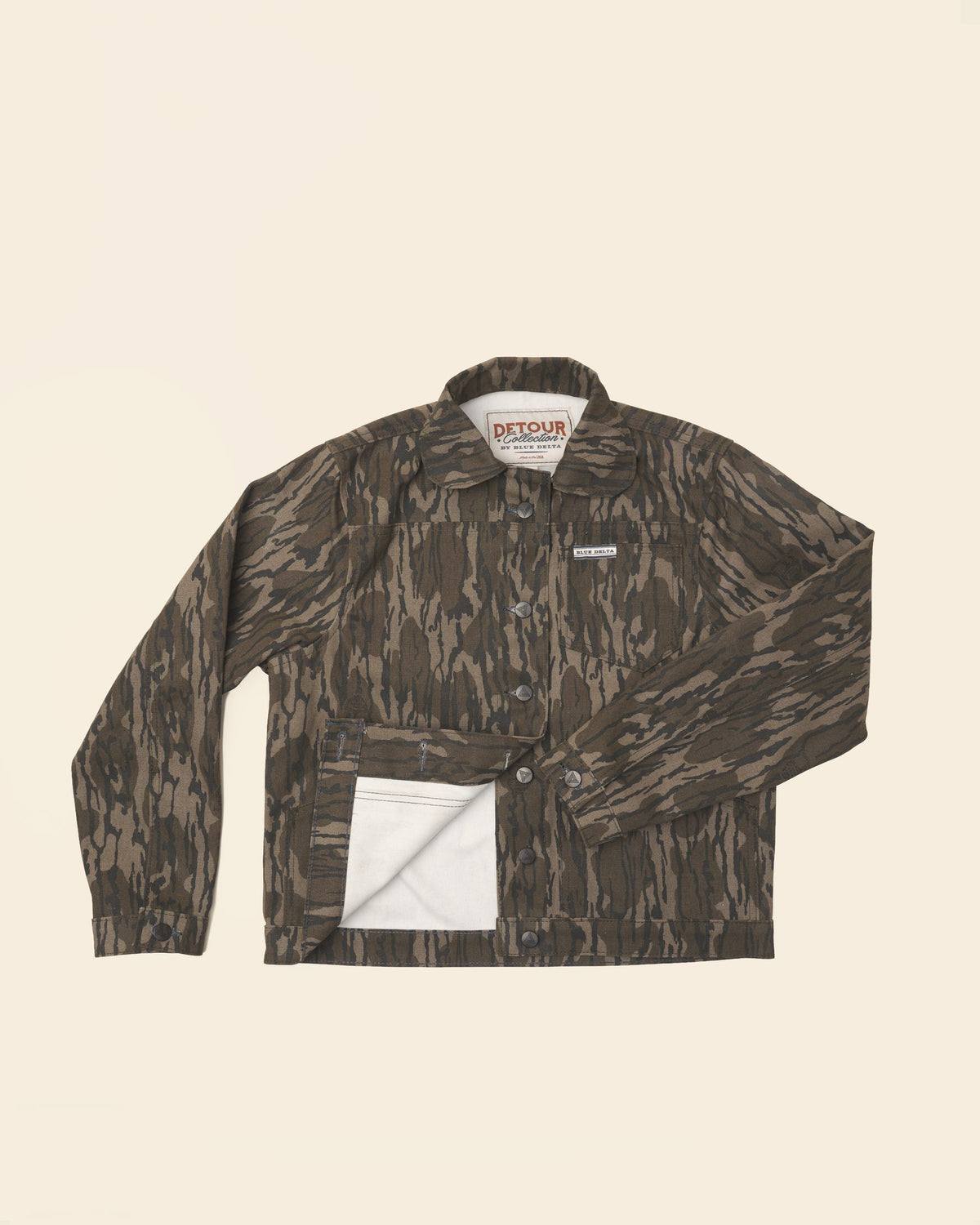 Women's Bottomland canvas jacket laid flat, lower front folded back to show the lining.