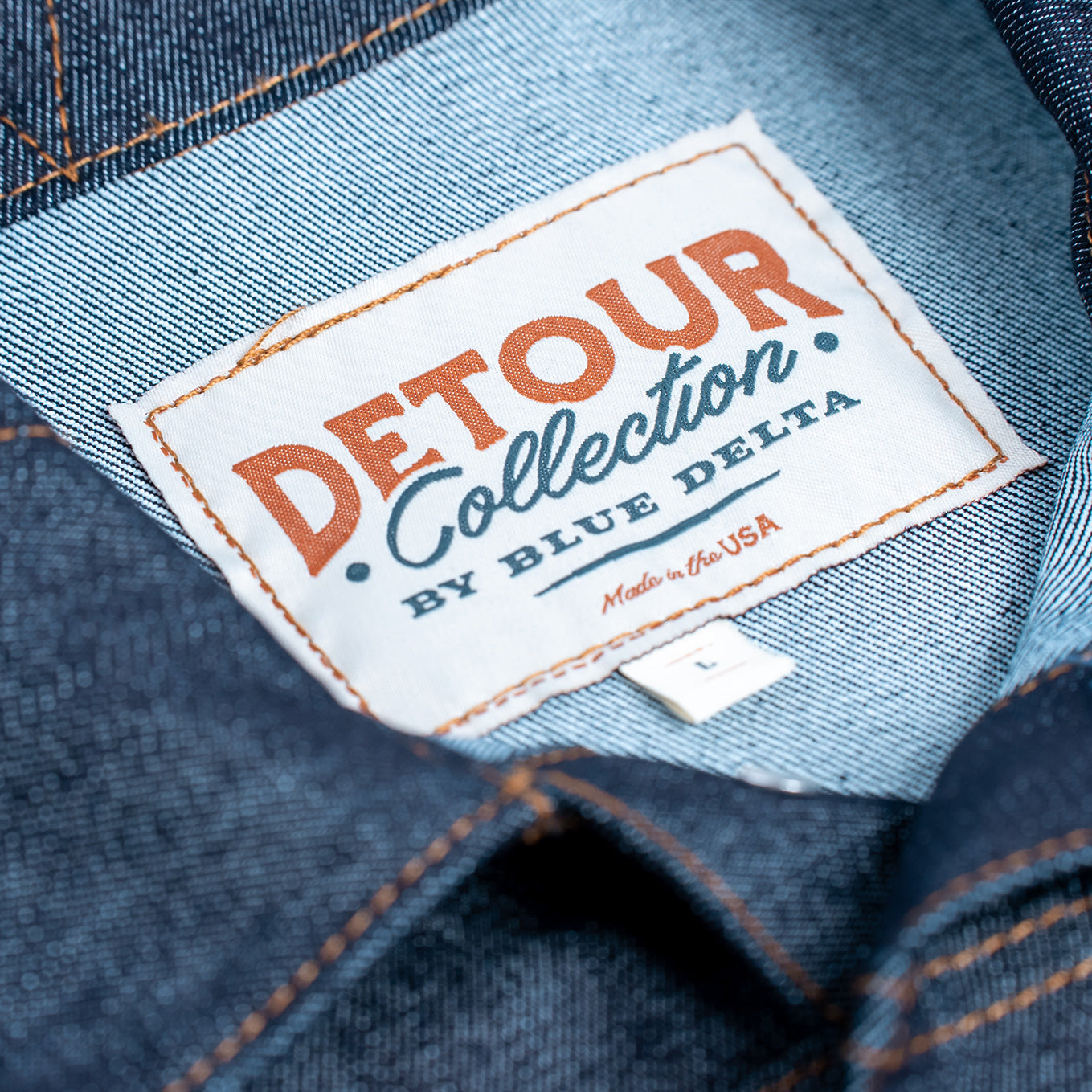Denim fabric with a 'Detour Collection by Blue Delta' label.