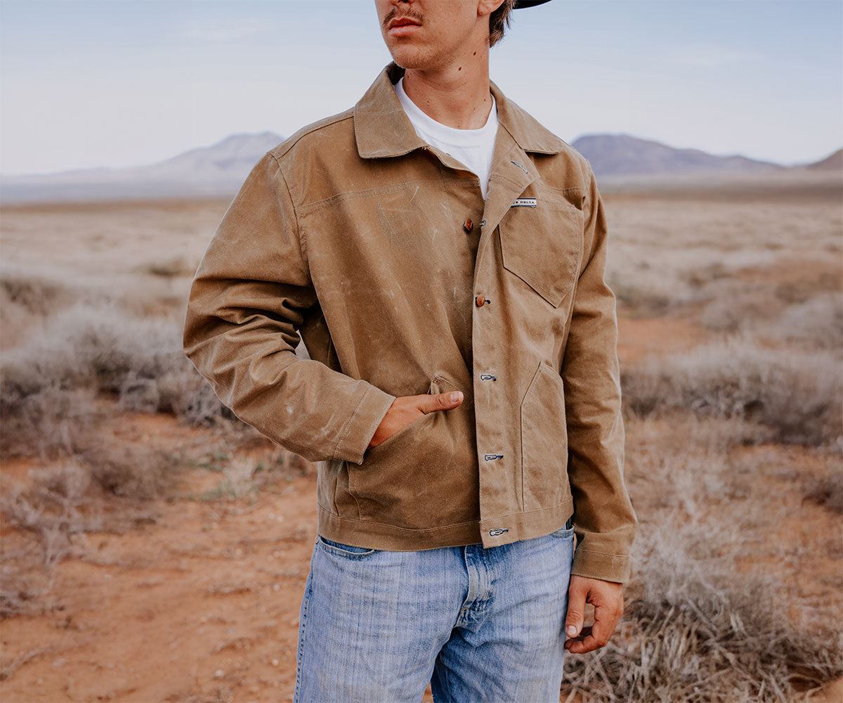 Man wearing The Rancher unlined waxed jacket layering with a sweater