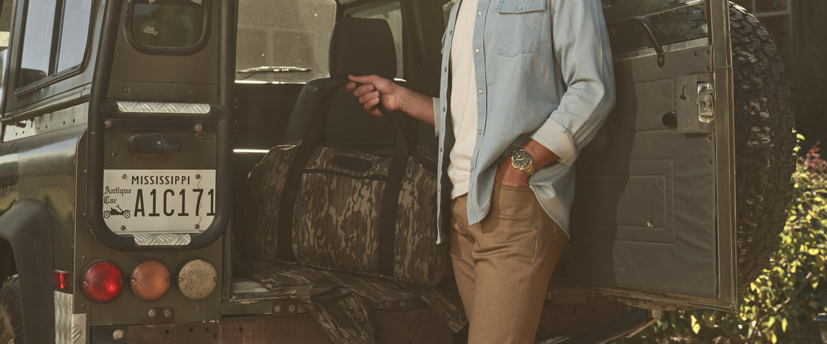 A Mossy Oak Bottomland duffle in the back of a vintage truck