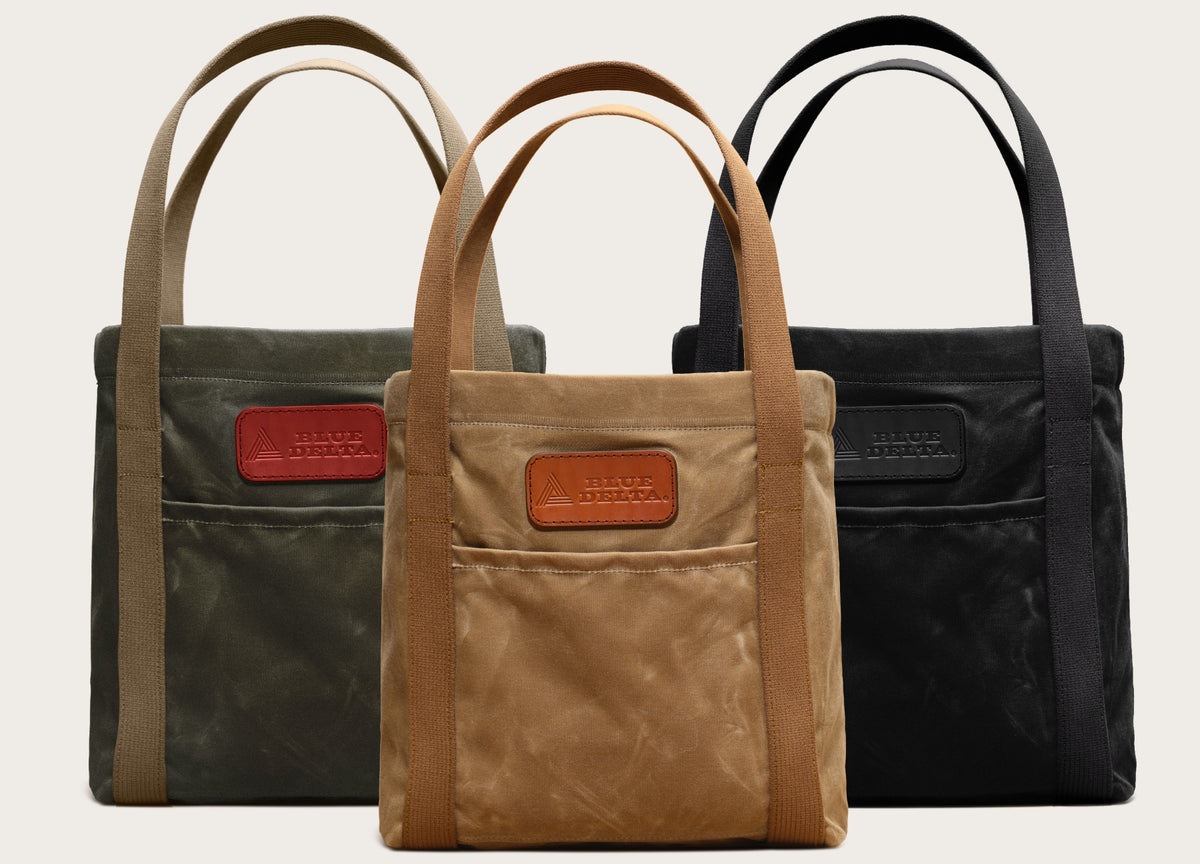 Wet-waxed canvas tote bags in forest green, whiskey and black