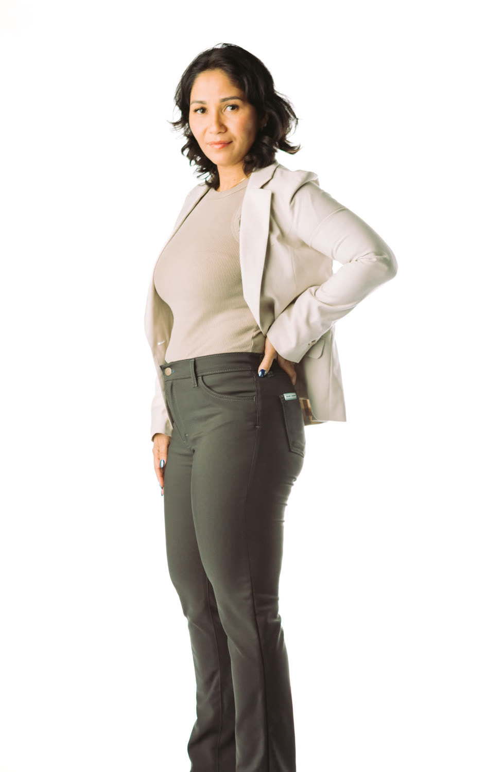 Woman in olive chinos and a cream blazer