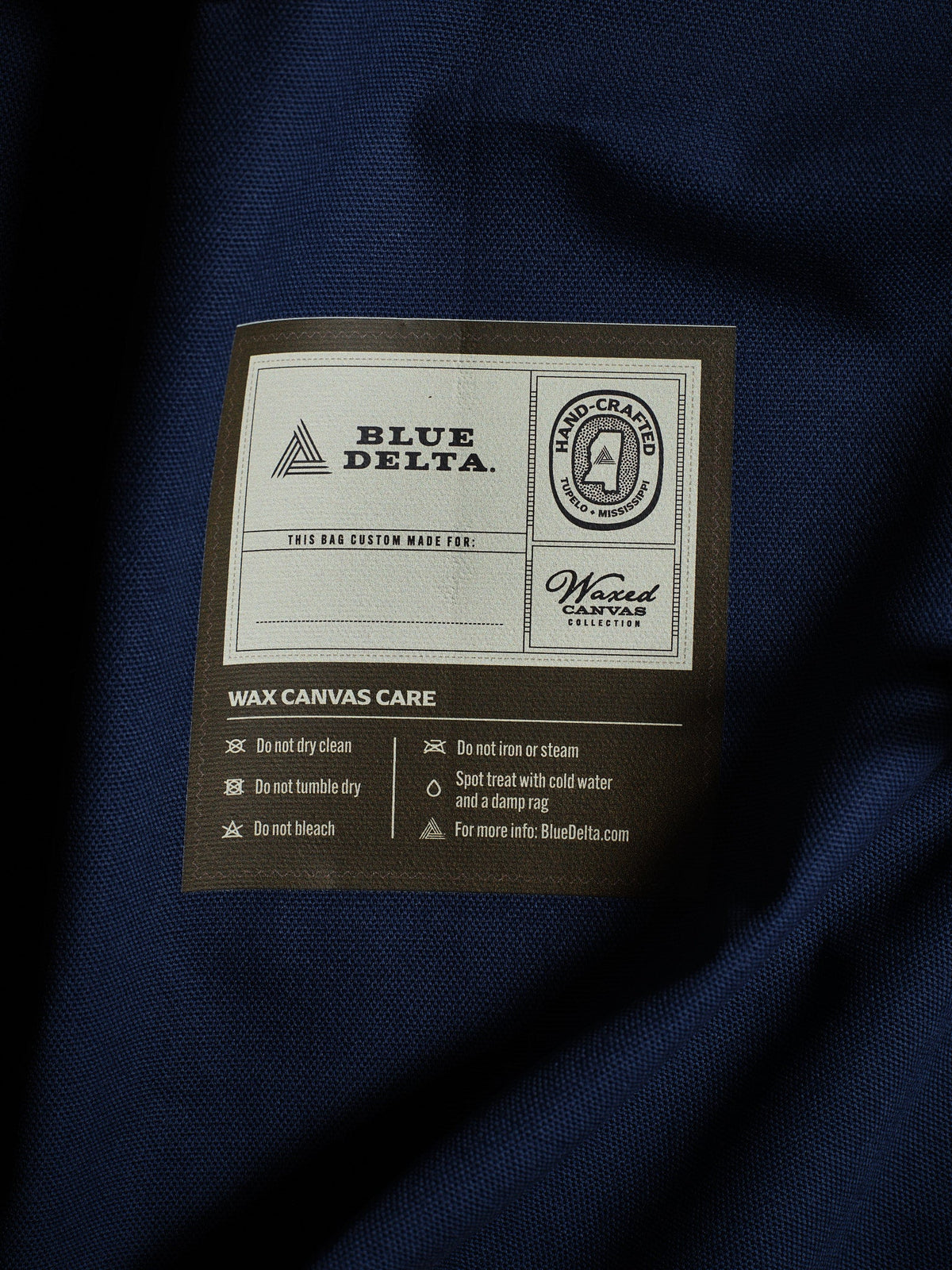 Waxed canvas care label sewn inside the bag