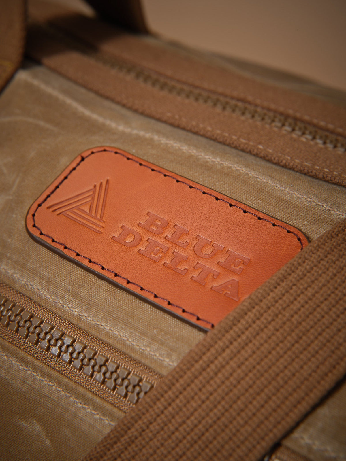 Waxed Canvas Duffle in tan: leather logo patch