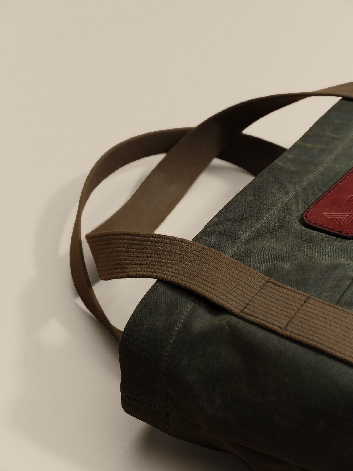Waxed Canvas Tote in green: leather patch and webbing handles
