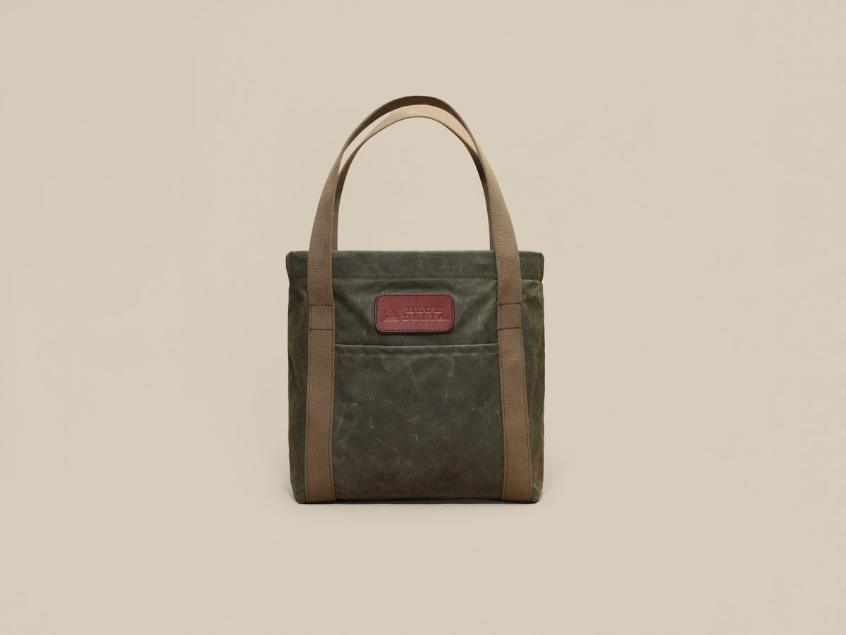 Waxed Canvas Tote in green waxed canvas with green webbing and a Chestnut leather patch, patch side