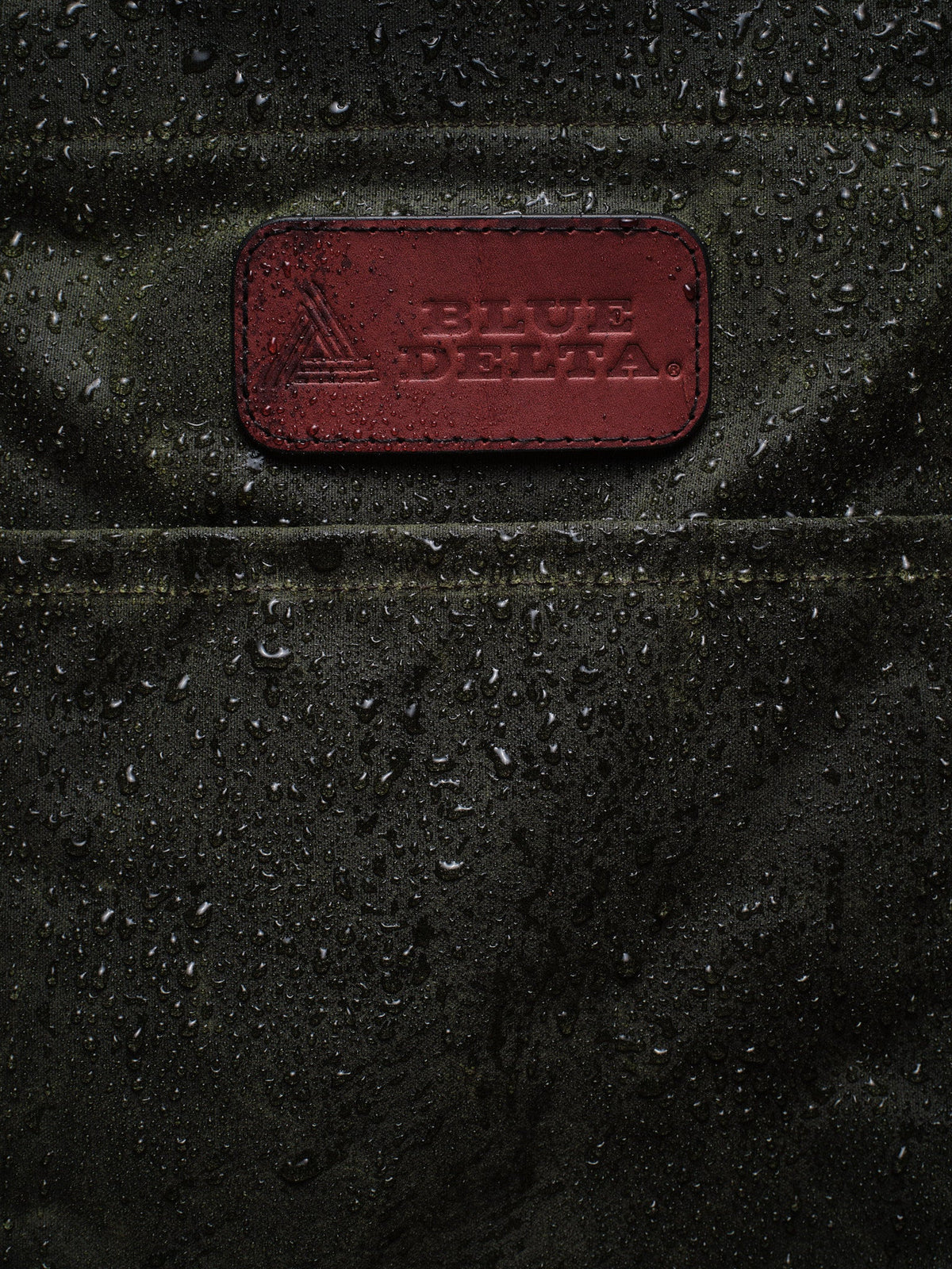 Waxed Canvas Tote in green: water beading around the leather patch