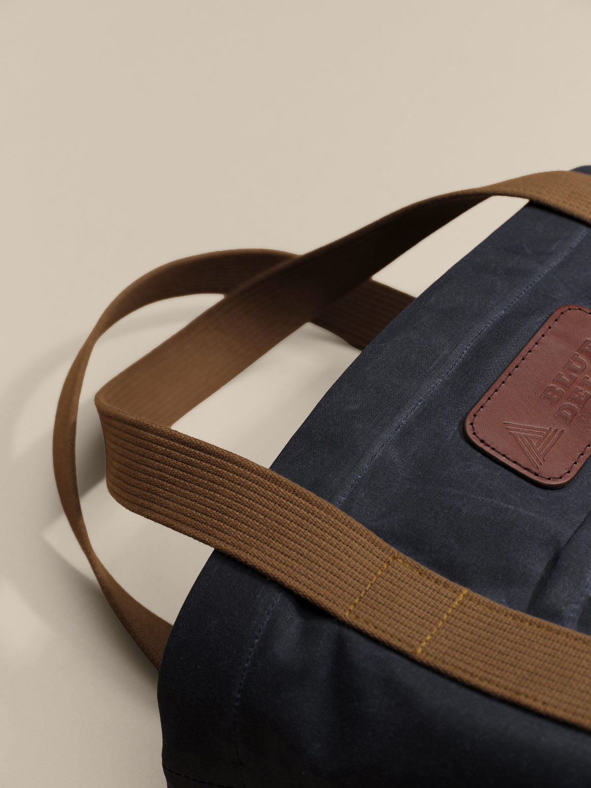 Waxed Canvas Tote in navy: leather patch and webbing handles