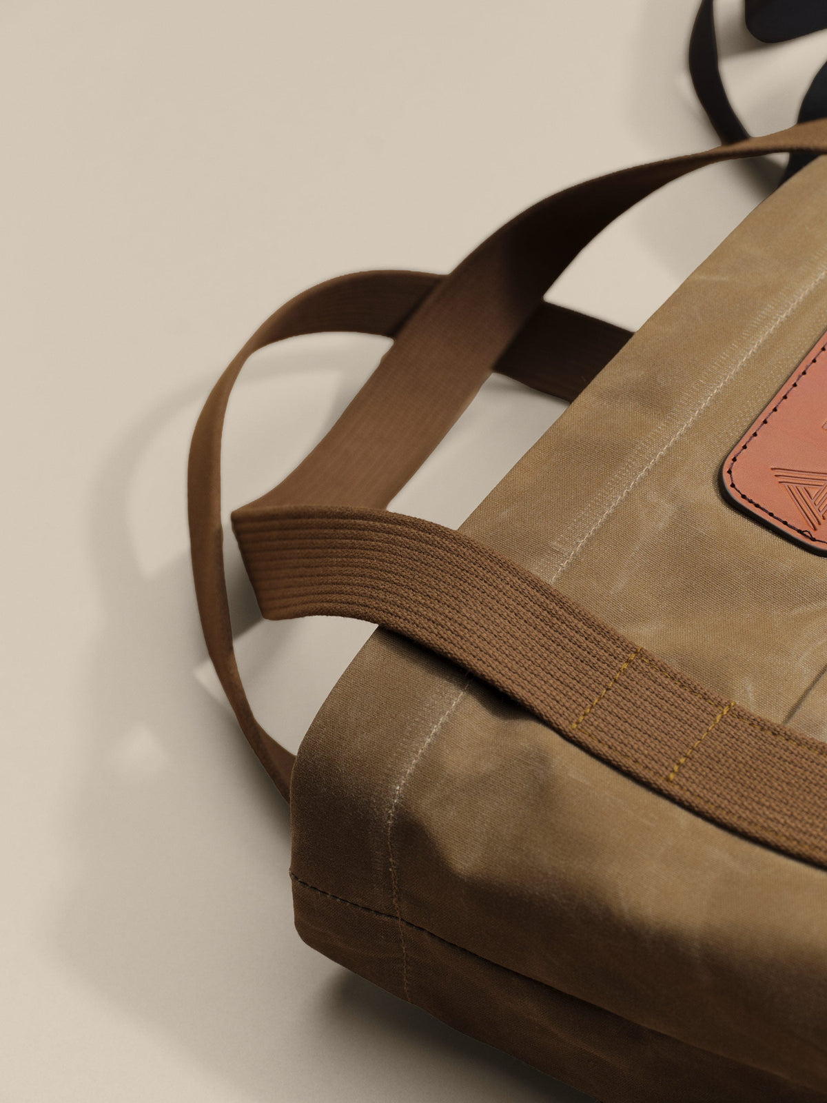 Waxed Canvas Tote in tan: leather patch and webbing handles