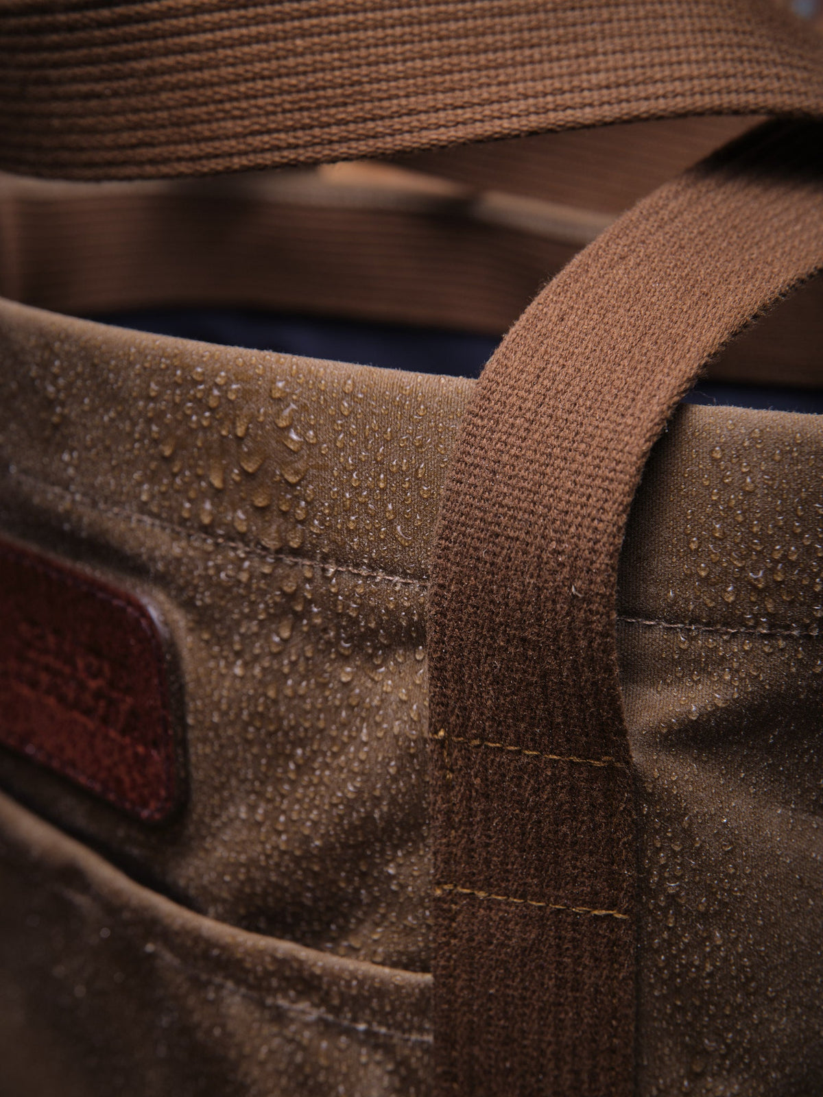 Waxed Canvas Tote in tan: water beading on the canvas by the handle